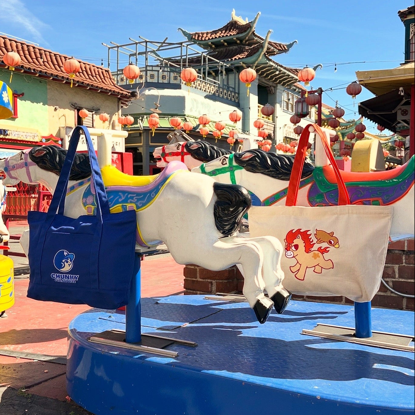 Colorful carousel horse with a blue bag on a sunny day